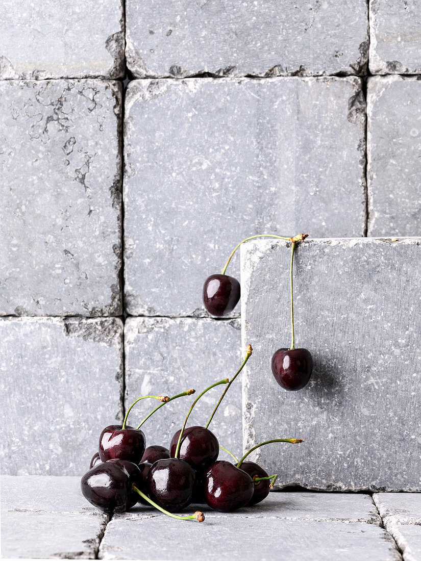 Cherries on and in front of stone wall