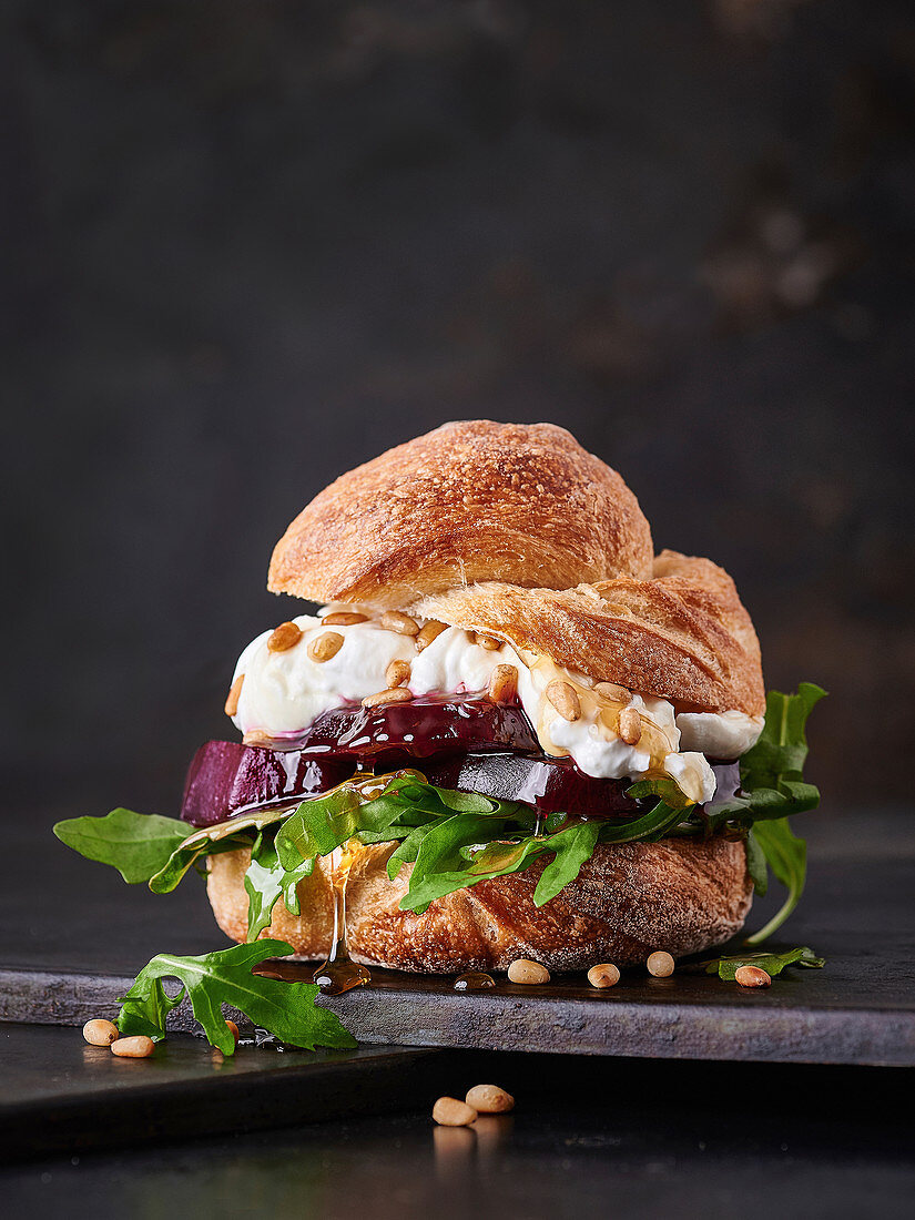 Beetroot burger with cream cheese, arugula, pine nuts and honey