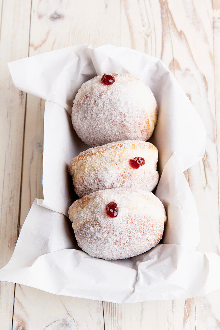 Doughnuts with strawberry jam and powdered sugar