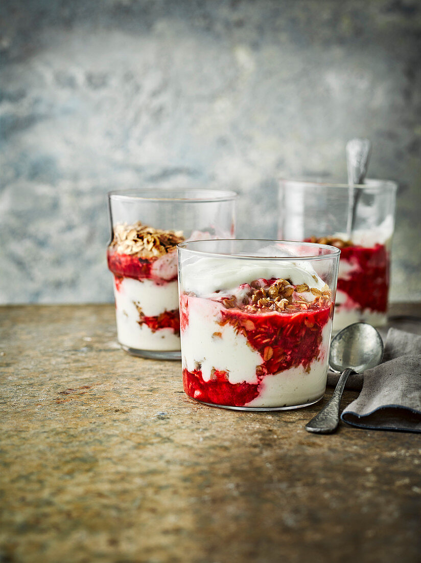 Vanilla yogurt cheesecake pots with flapjack crumble and raspberries