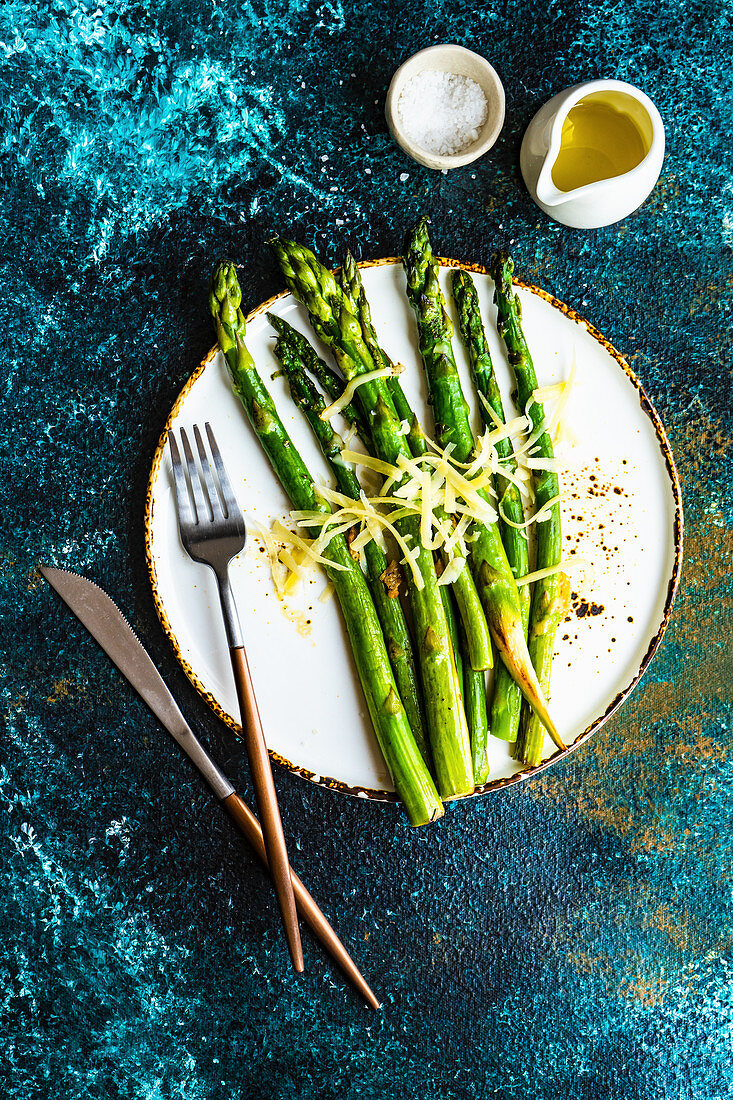 Organic grilled asparagus served for healthy keto lunch on stone background with copy space