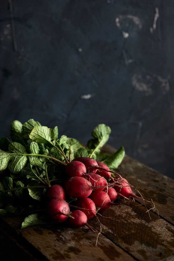 Fresh radishes on a wooden background