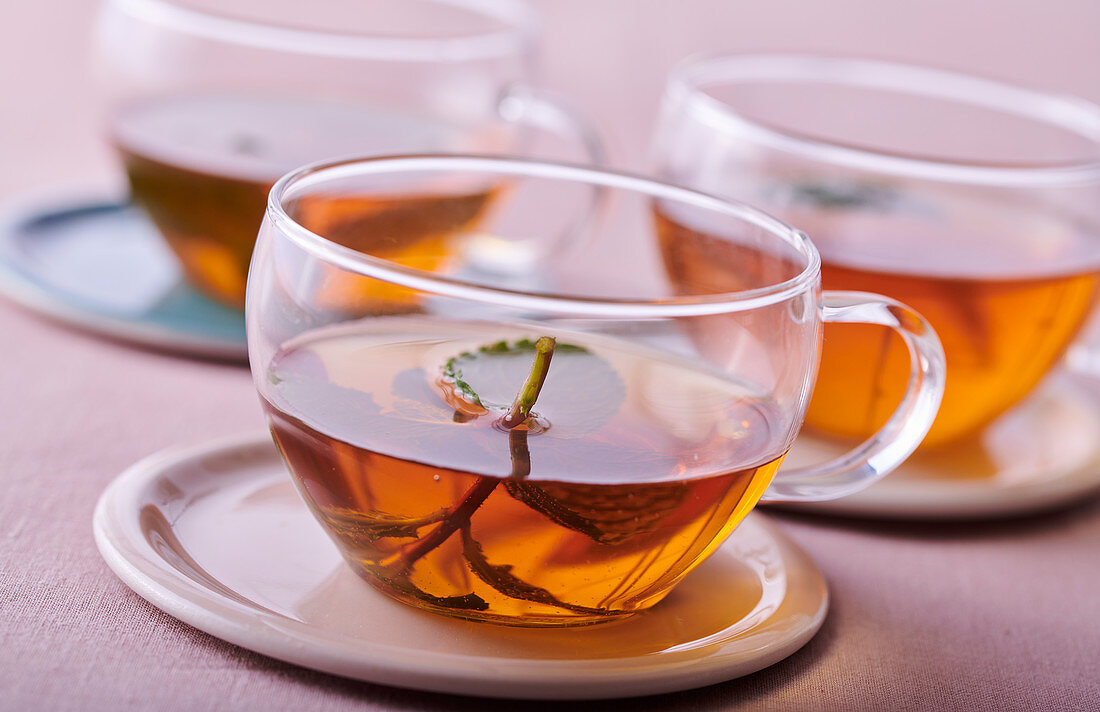 Three glass cups with tea