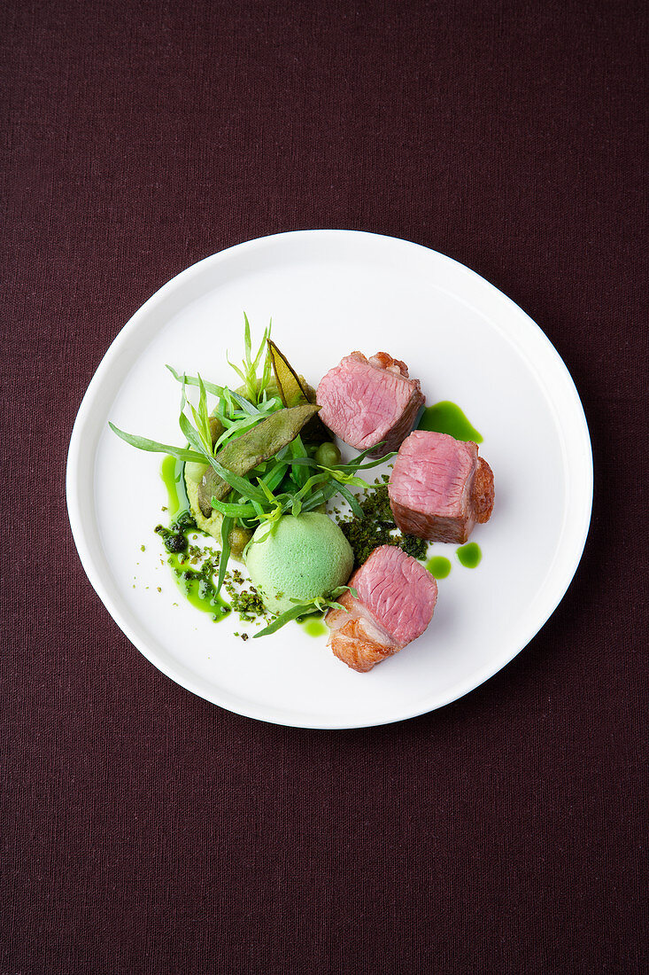 Saddle of lamb with tarragon honey, peas, and mountain cheese flan