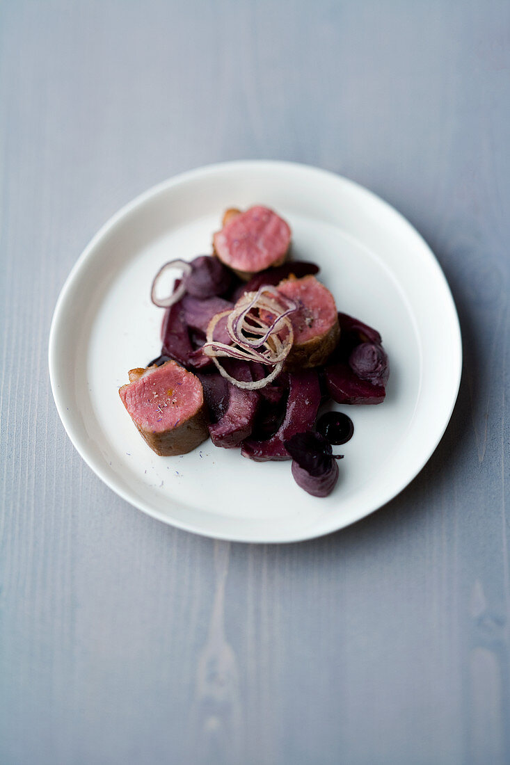 Saddle of lamb and violet glaze, with cassis artichokes