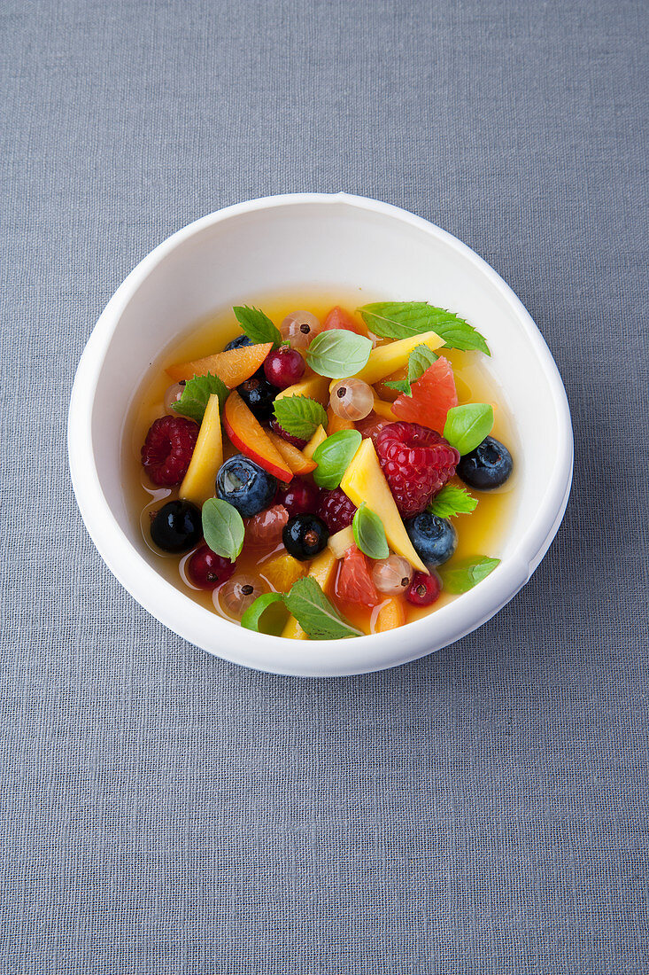 Summer fruit salad with basil and mint syrup