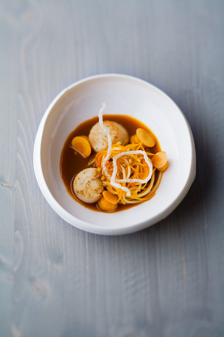 Scallops with carrot and sauerkraut and orange blossom dashi