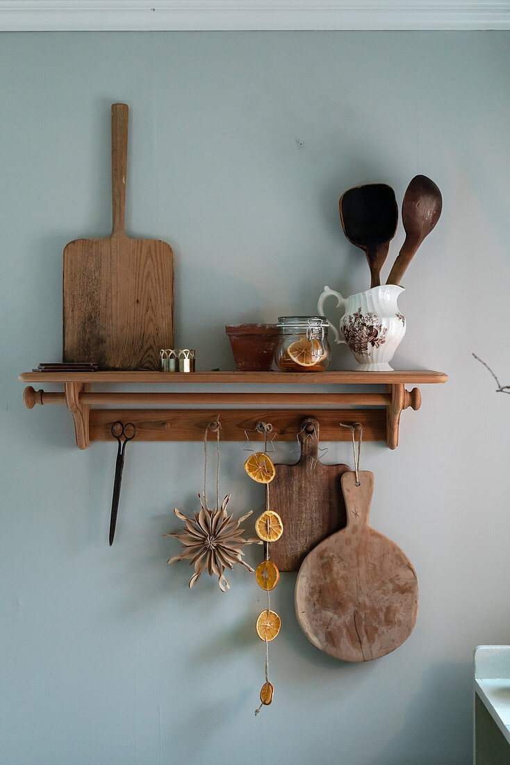 Kitchen utensils and chopping board on rustic shelf