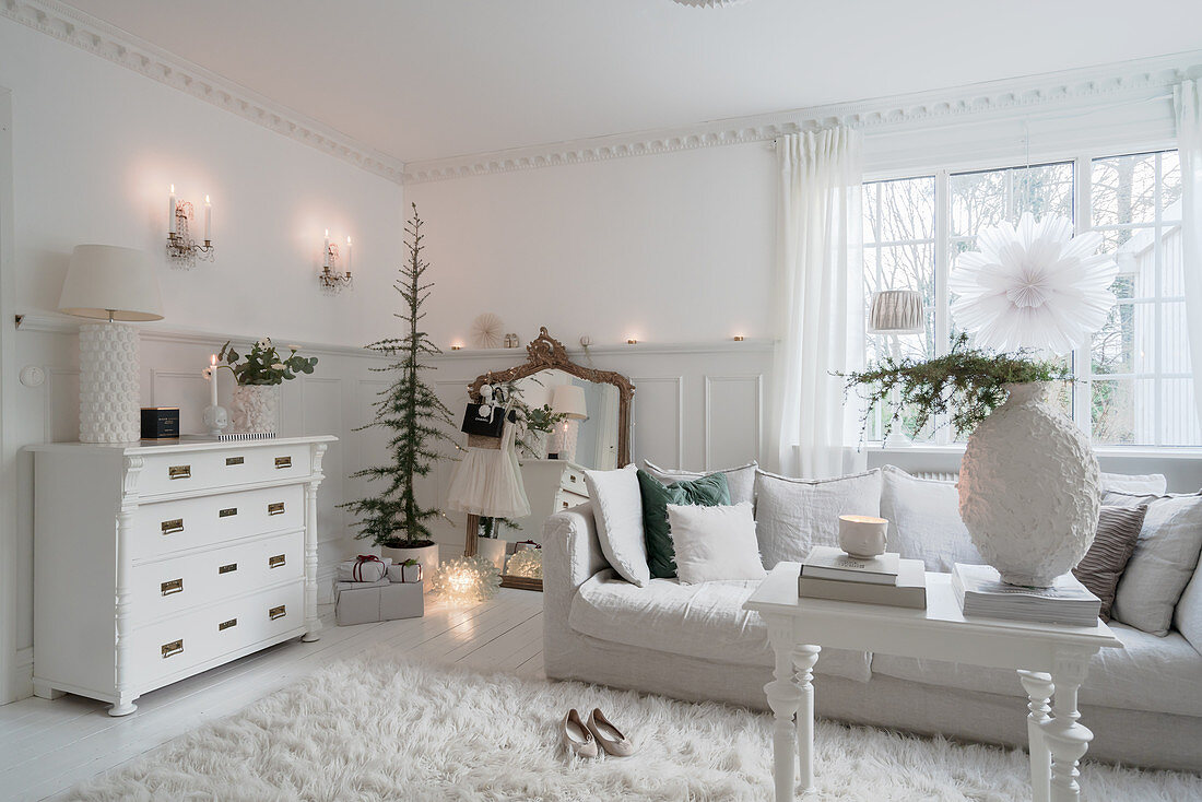 Christmas decorations in classic, white living room