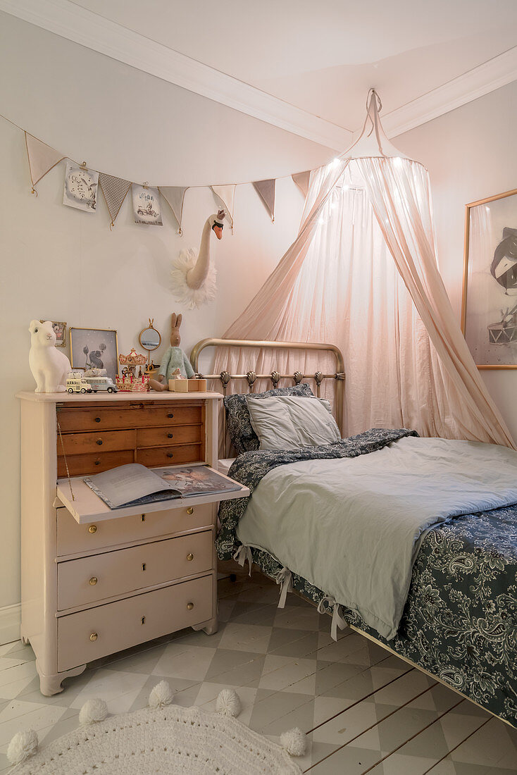 Antique bureau and metal bed in vintage-style child's bedroom
