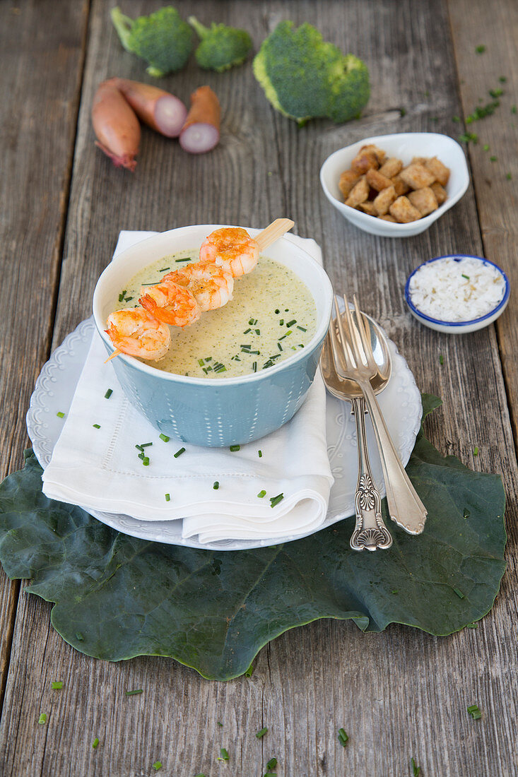 Broccoli cream soup with fried shrimp skewers