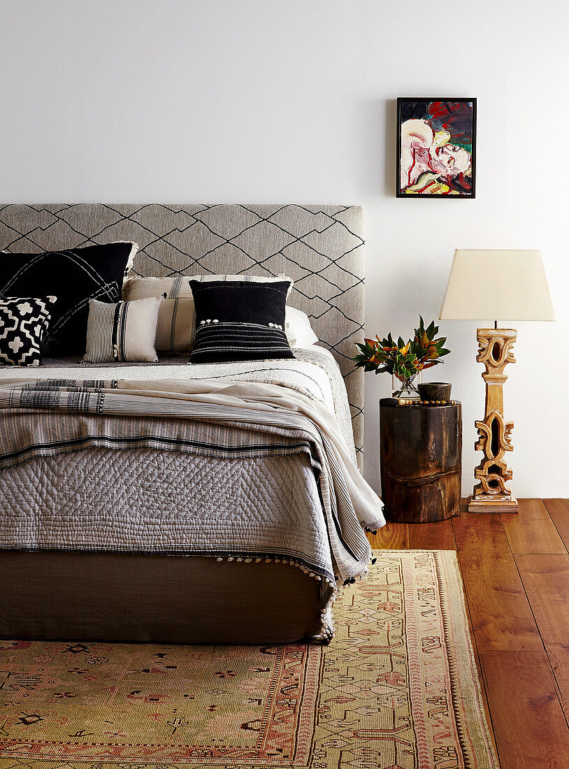 Double bed with headboard upholstered in diamond-patterned fabric