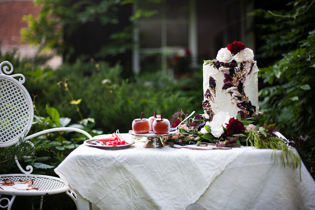 High cream cake with fruit jelly and gold leaf