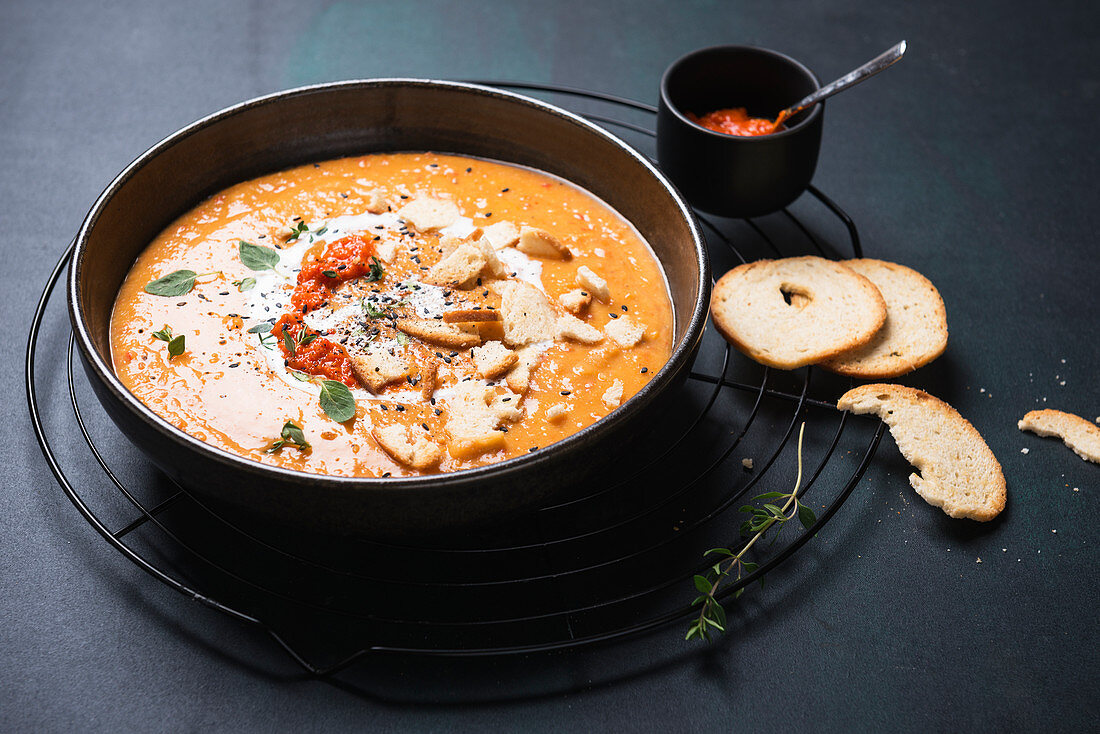 Vegan bell pepper and potato soup with ajvar and garlic bread chips