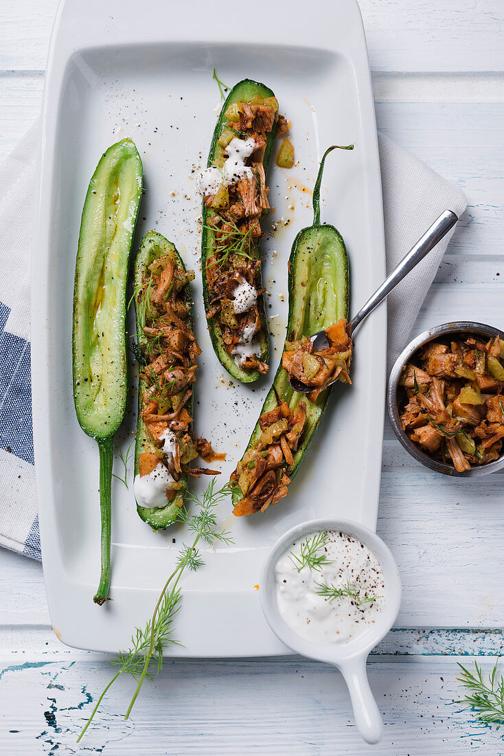 Mini braising cucumbers filled with pulled jackfruit and a vegan dill cream dip