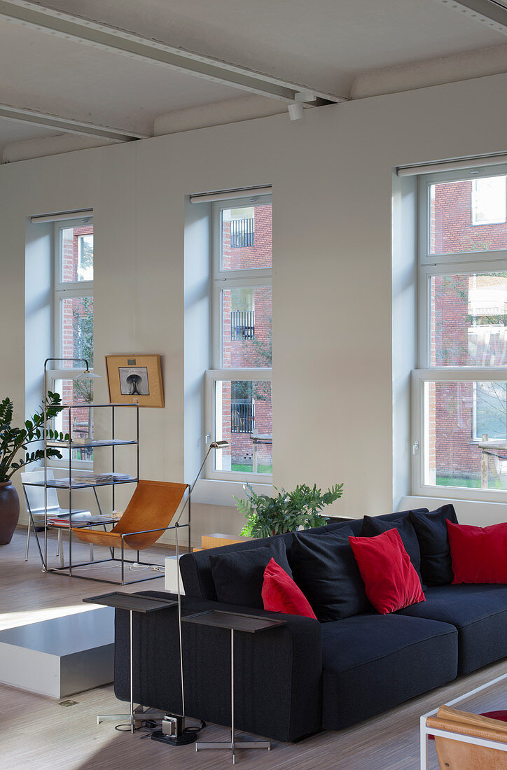 Grey sofa with scatter cushions in loft apartment