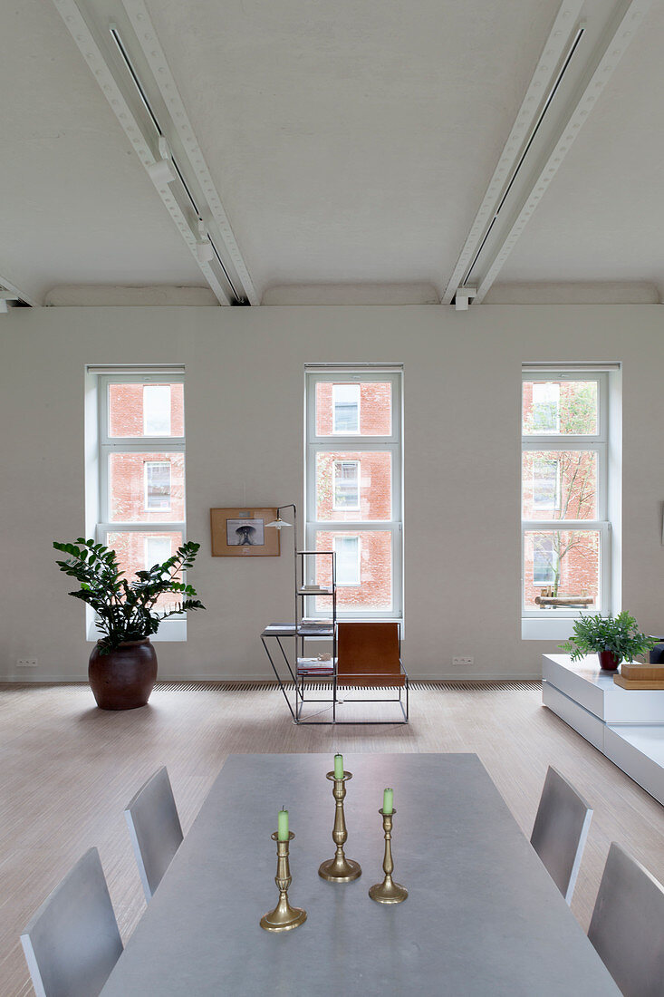 Pale dining table in loft apartment