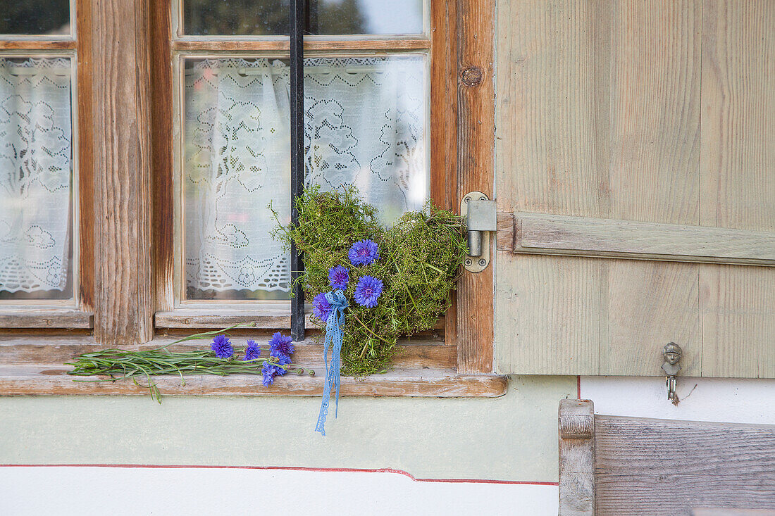 Moss heart decorated with cornflowers