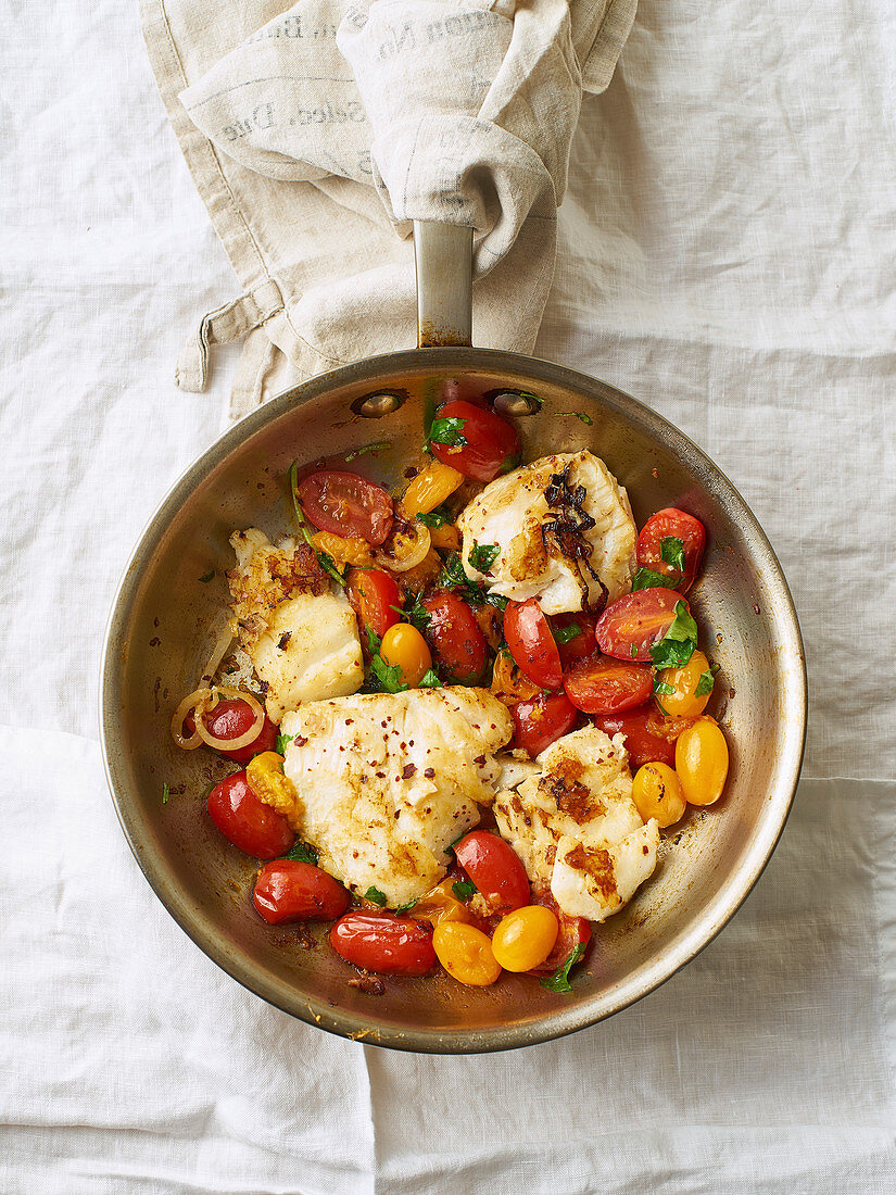 Roasted white fish with cherry tomatoes and lemon rind