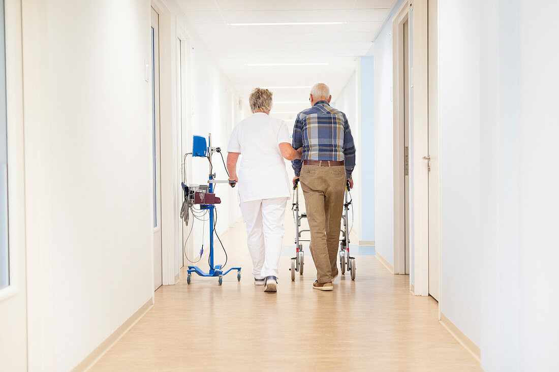Nurse and patient walking in hallway