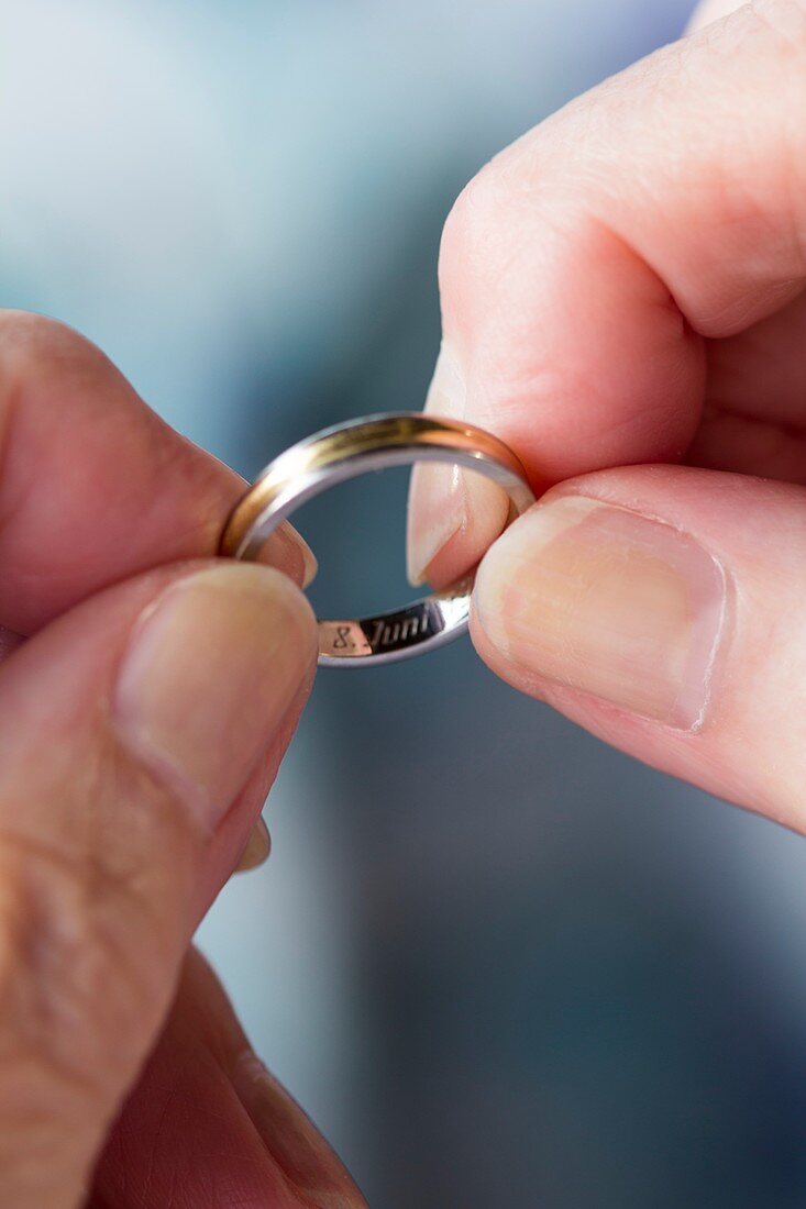 Hands holding wedding ring