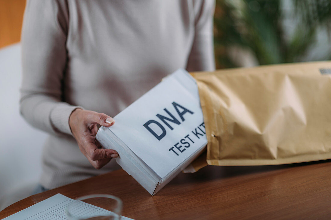 Senior woman preparing DNA test kit