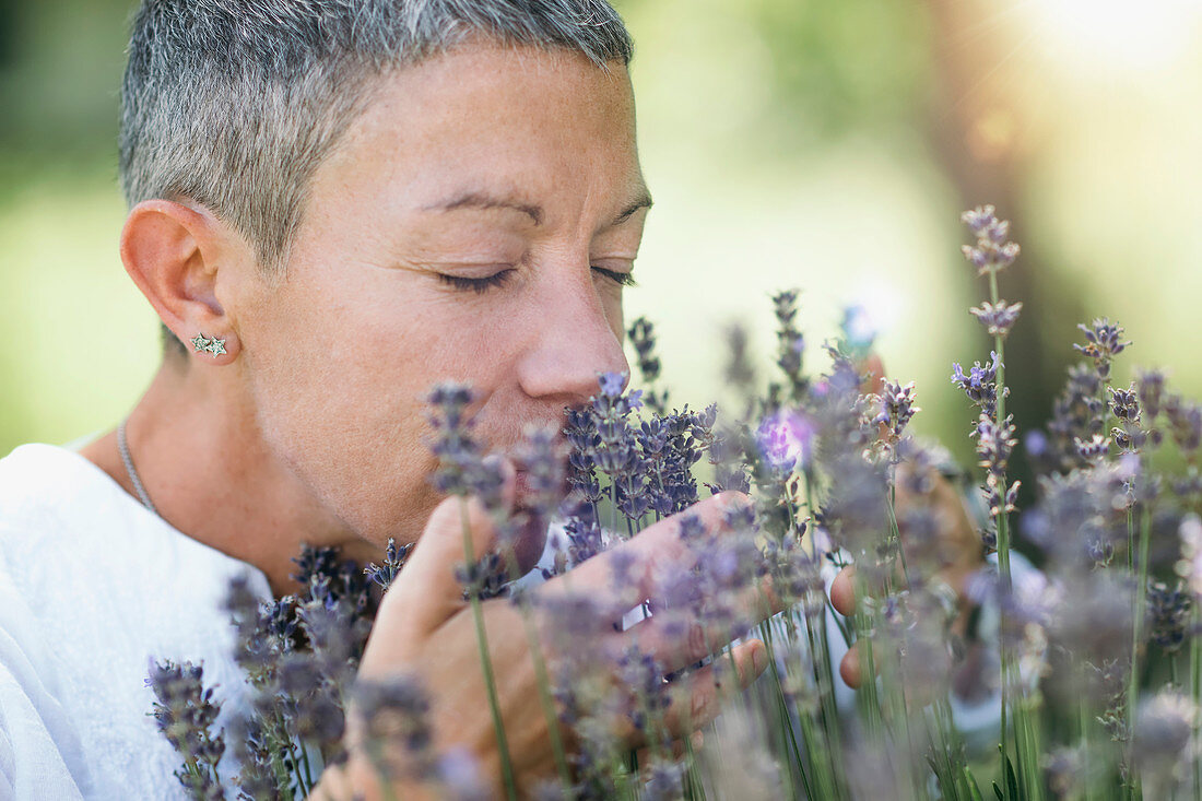 Woman enjoying the scent of lavender