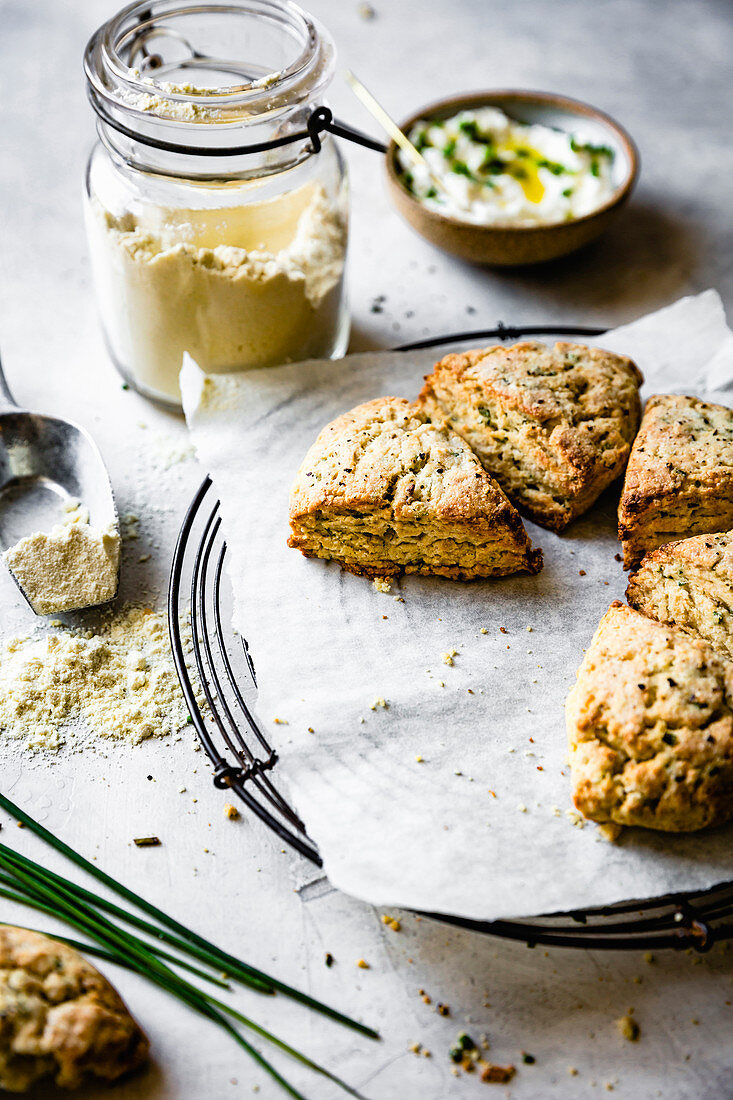 Cheese and herb scones beside a jar of oat flour