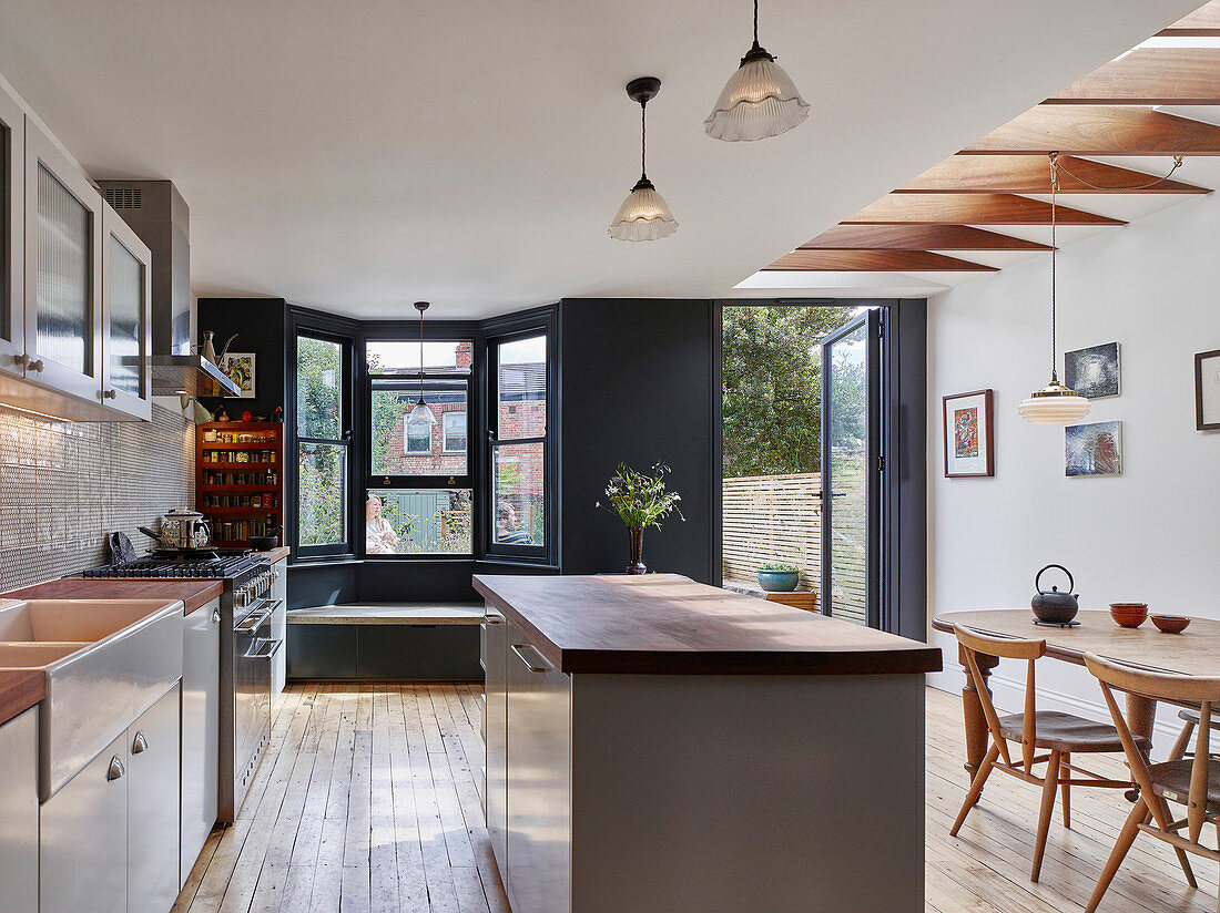 Classic kitchen-dining room with bay window and door leading into garden