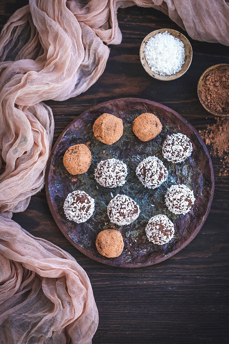 Homemade chocolate almond truffles served on a ceramic plate