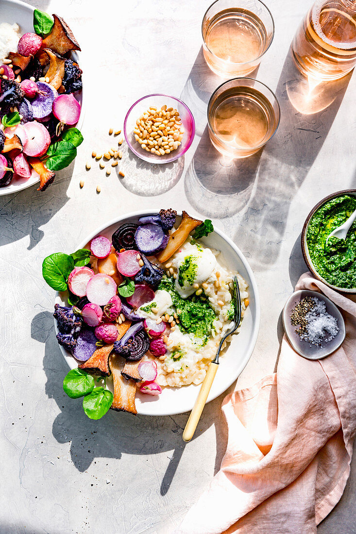 Sunlight on glasses of sweet wine and risotto with roast radishes.