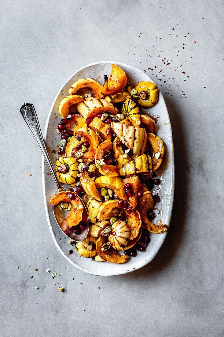 Roasted delicata squash with pomegranate and pistachios.