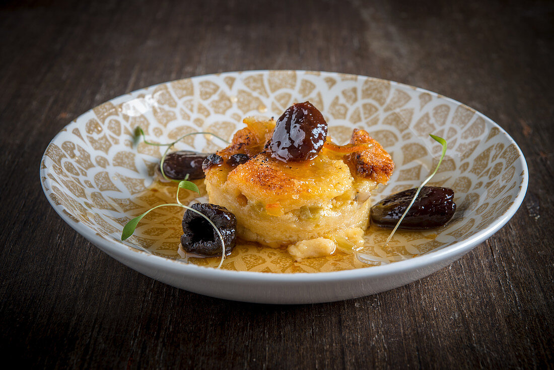 Bread and Butter Pudding with Prunes on a wooden background