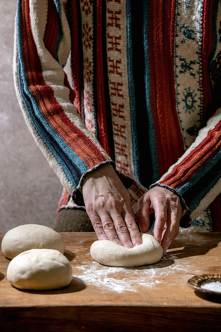 Preparing pizza: kneading balls of dough