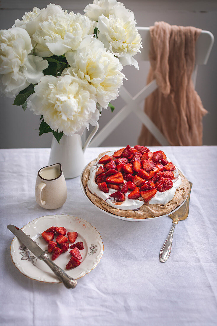 Pavlova cake with whipped cream and strawberries