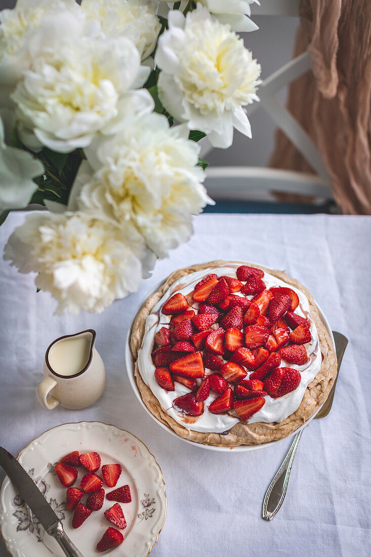 Pavlova cake with whipped cream and strawberries