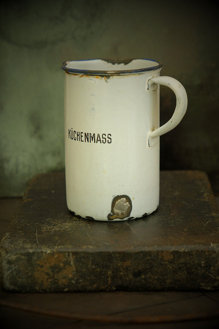 An old enamel measuring jug