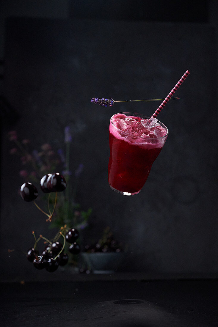 A floating Gin Sour with beetroot and cherries