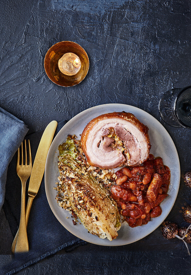 Festive porcetta, one-pan pigs-in-blanket beans and roasted hispi cabbage with garlic and chilli crumb