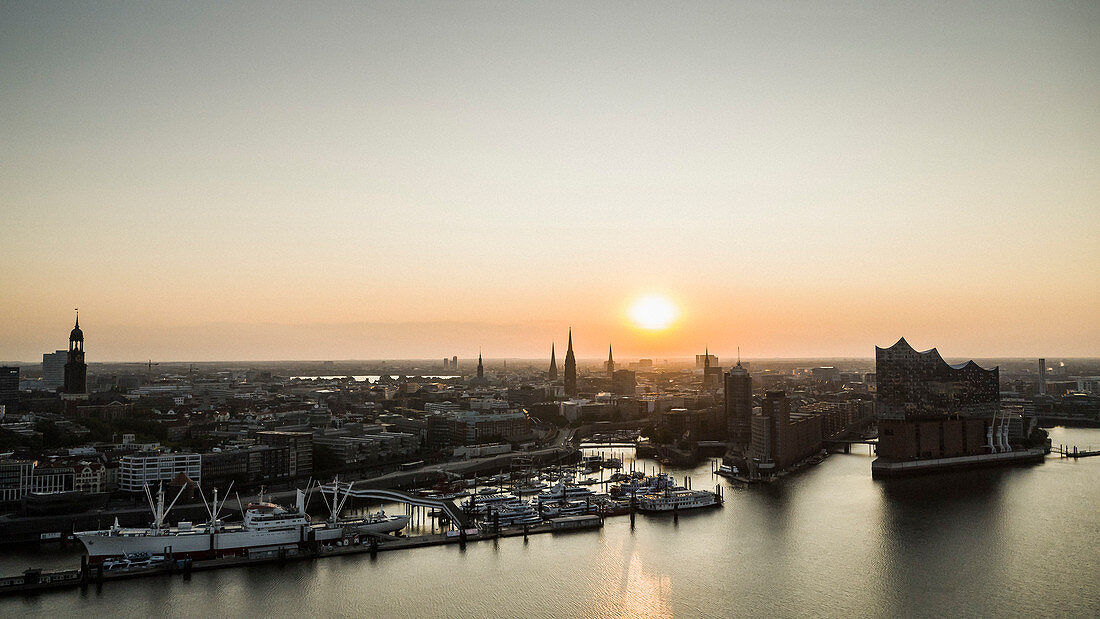 Sunset over tranquil Hamburg cityscape and Elbe River, Germany