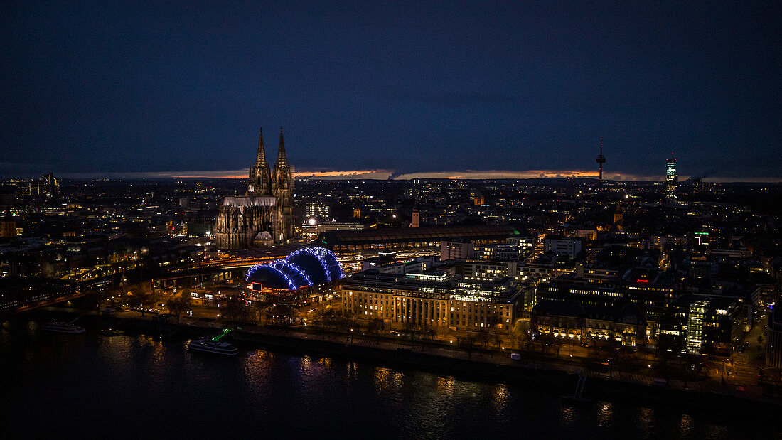 Illuminated Cologne Cathedral and cityscape at night, Germany