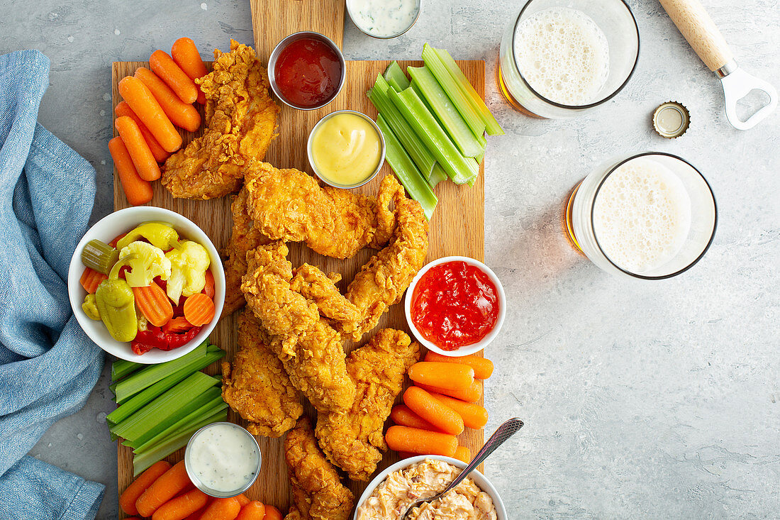 Southern fried chicken platter with all the sauces celery and carrots