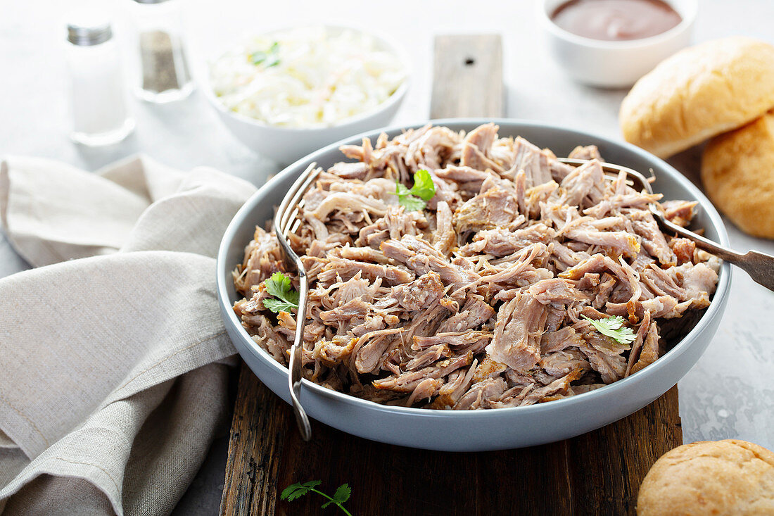 Pulled pork on a platter with cole slaw and bbq sauce