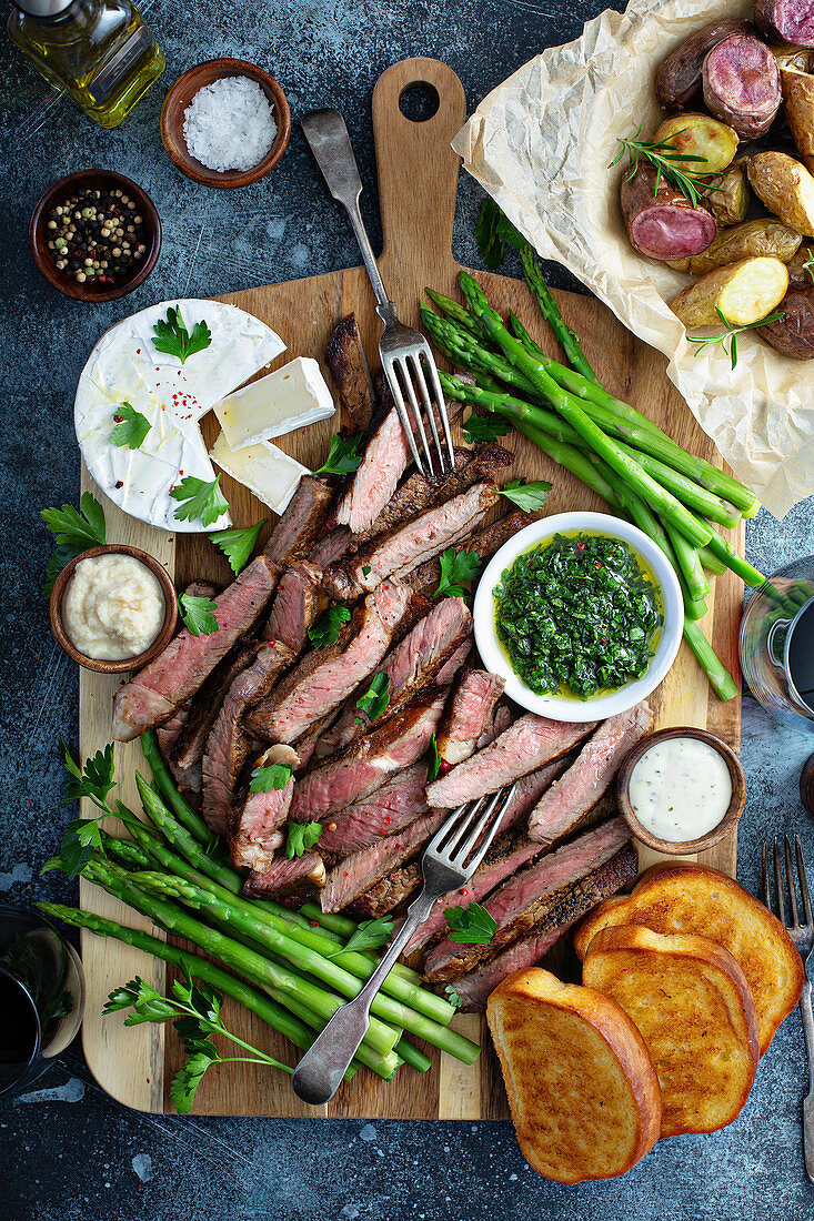Steak and asparagus platter with potatoes and toast