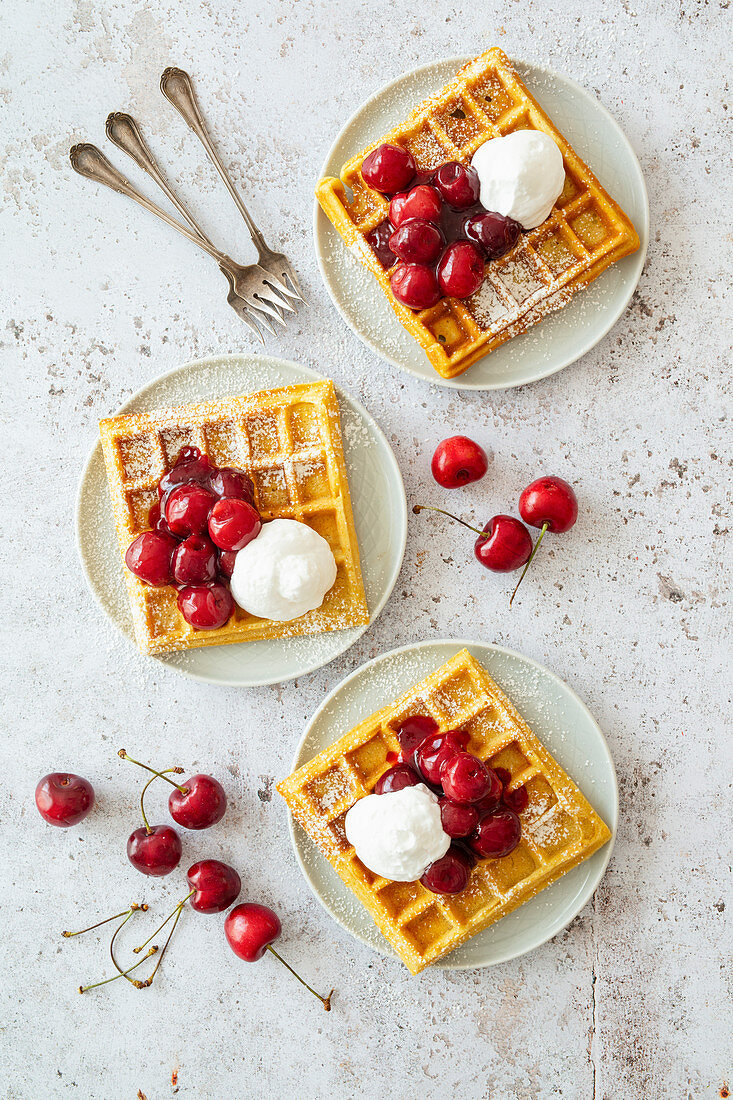 Vegan Belgian waffles with fresh cherries and vegan cream