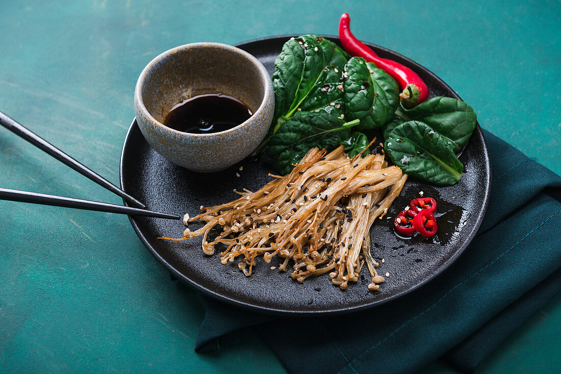 Baked enoki mushrooms with misome salad and a spicy soya and chilli dressing