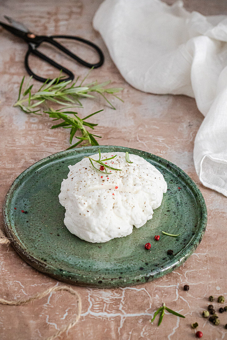 Vegan coconut 'labneh cheese' with with rosemary and colored pepper