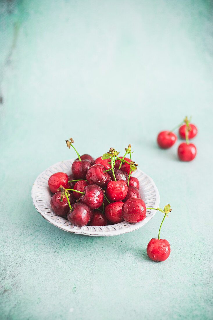 Cherries in a bowl on a light background