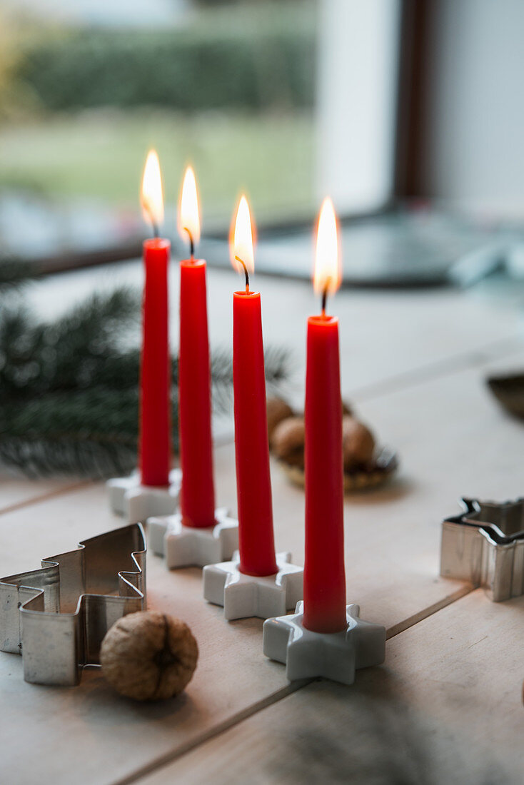 Red Advent candles in star-shaped candle holders