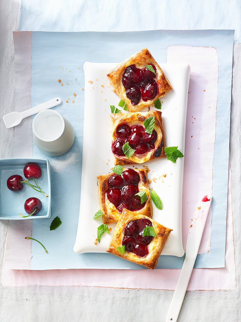 Square puff pastry tarts with vanilla cream and cherries